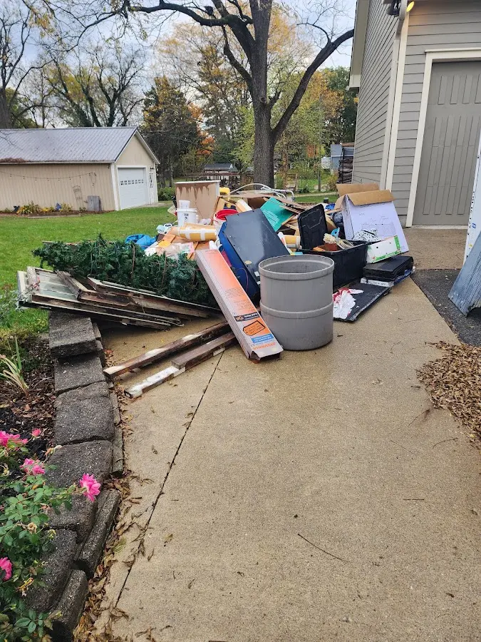Dumpster being loaded with debris for 30 Yard Dumpster Rental in Brimfield